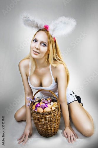 sexy woman easter bunny with basket of eggs