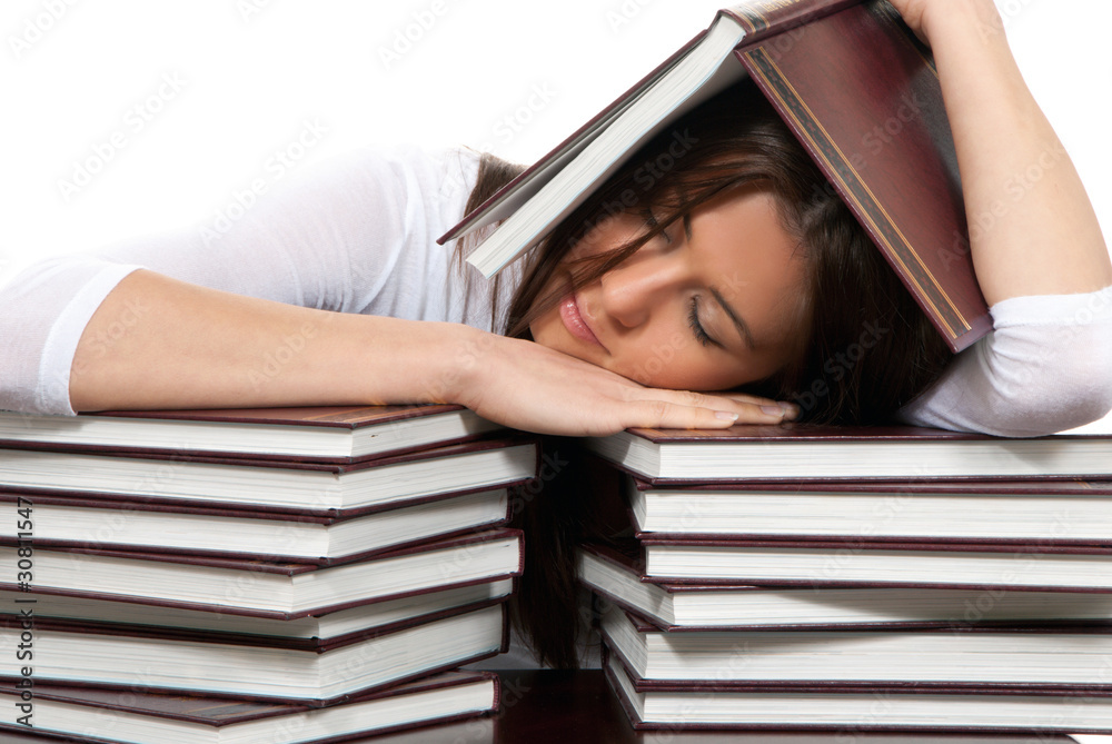 Young tired student is under and over books Young tired student is under and over books