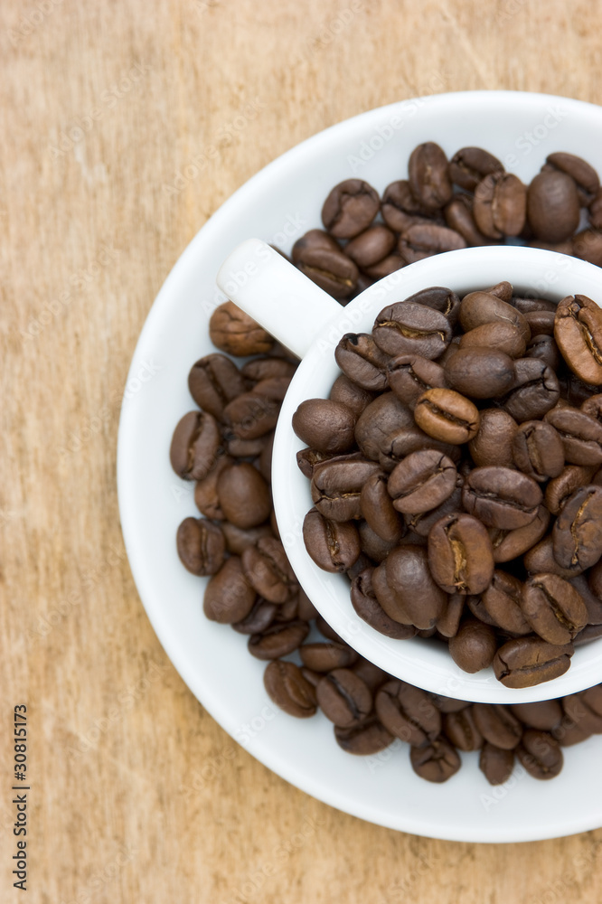 Cup with coffee beans Cup with coffee beans