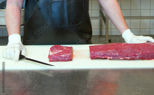 Sliced meat at the butchers station photo