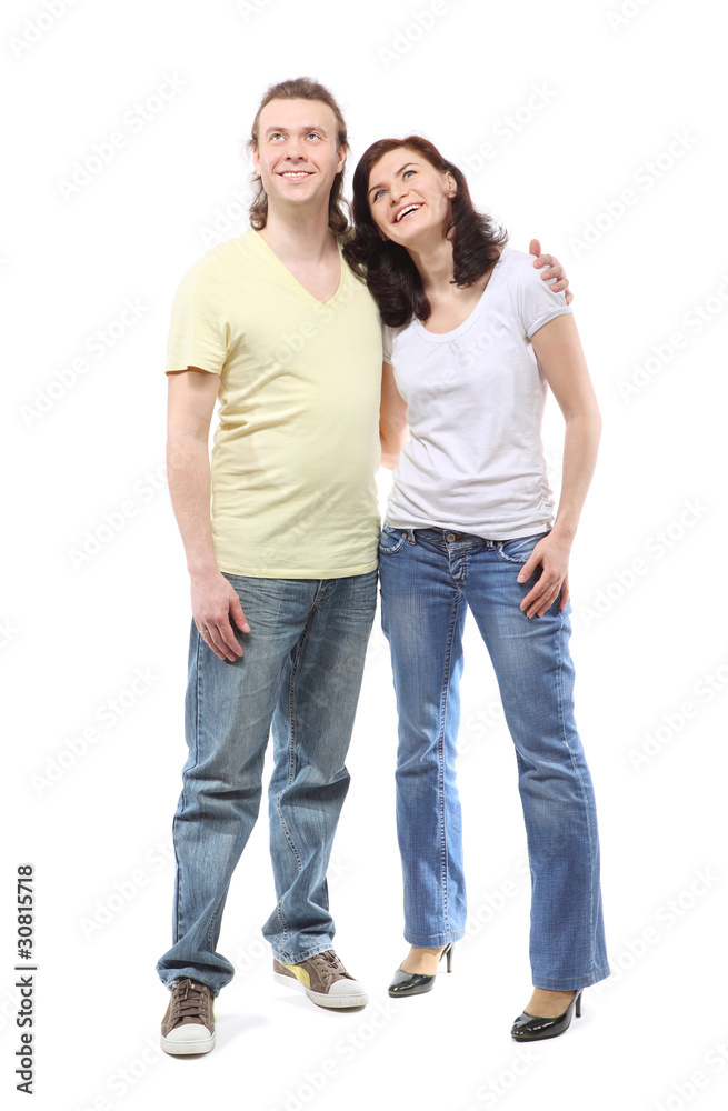 Young couple in jeans, boy and girl, are standing in embrace
