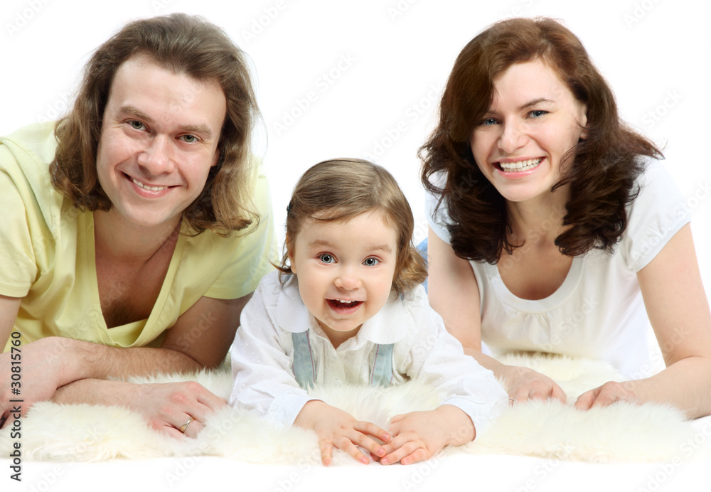 Happy young family are lying on white fluffy fur Happy young family are lying on white fluffy fur