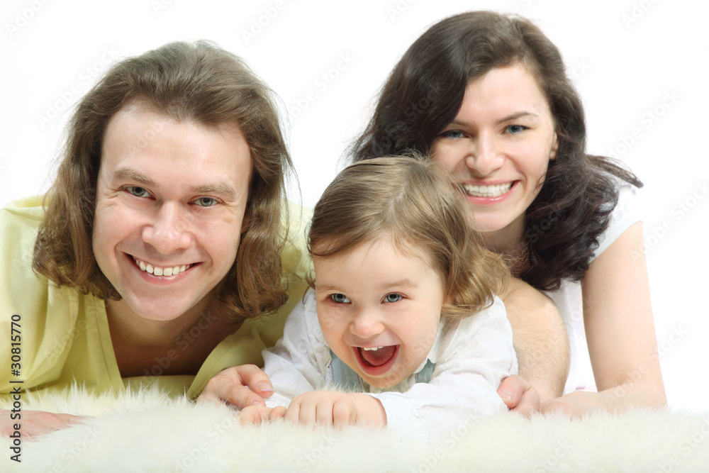 Happy young family - mother, father and playful little daughter Happy young family - mother, father and playful little daughter