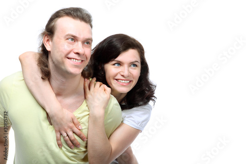 Portrait of happy young couple in love looking to side