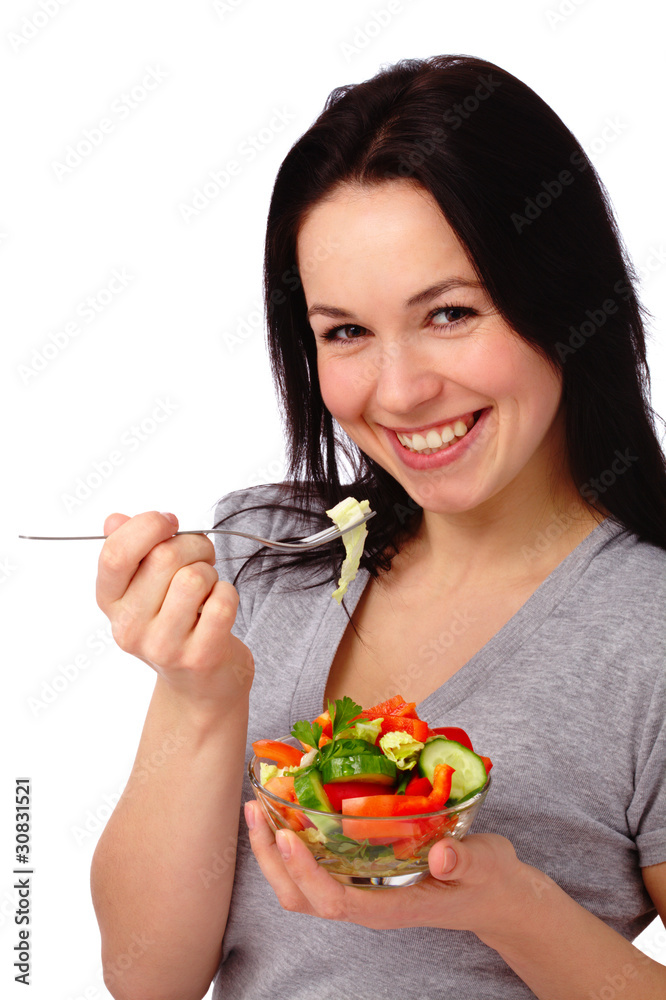 Young attractive woman eats vegetable salad Young attractive woman eats vegetable salad