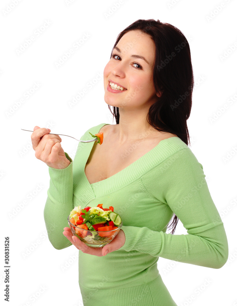 Young attractive woman eats vegetable salad Young attractive woman eats vegetable salad