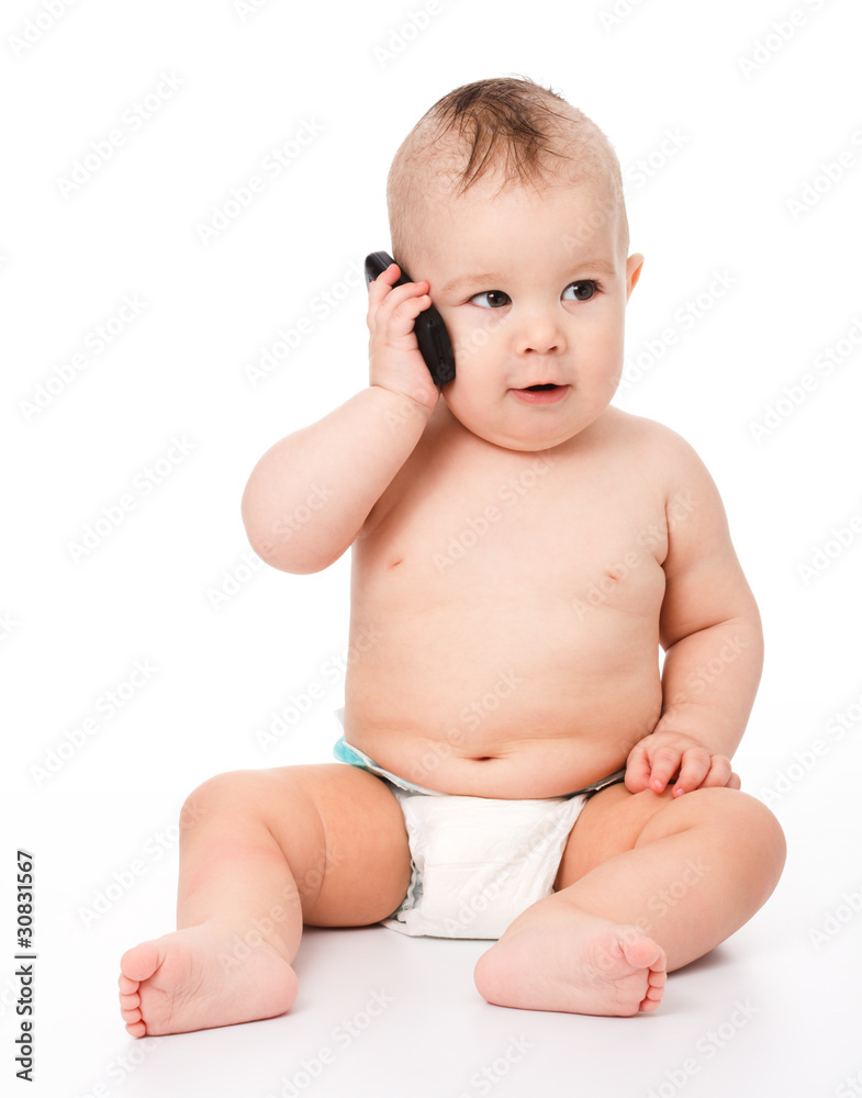Cute little baby is talking on cell phone Cute little baby is talking on cell phone