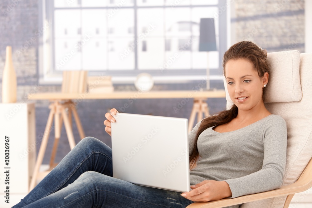 Attractive female browsing internet at home Attractive female browsing internet at home