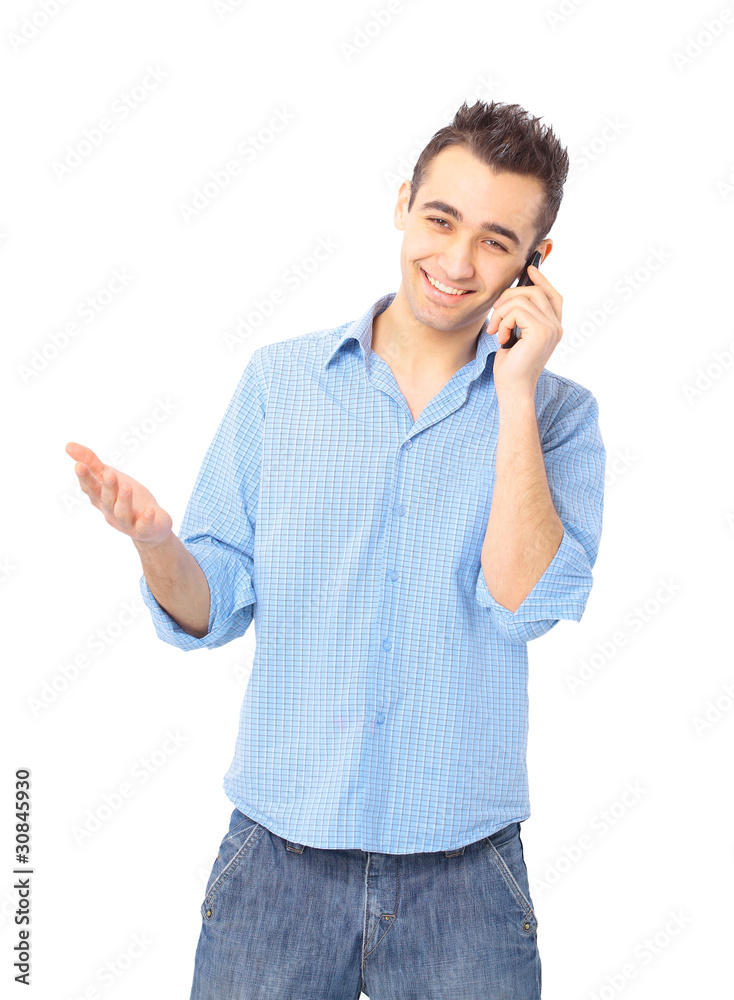Smiling young man, wearing blue shirt, talking on mobile Smiling young man, wearing blue shirt, talking on mobile