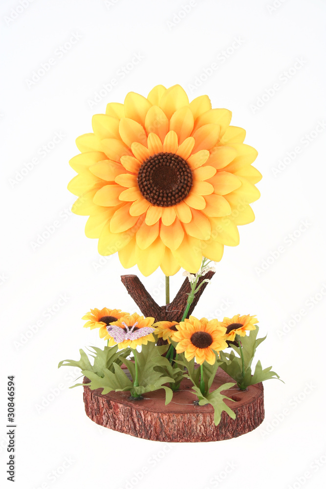 Big Artificial Sunflower and several small sunflowers with butte
