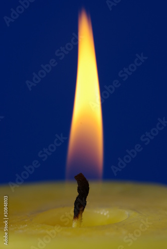 Gelbe Kerzenflamme blauer Hintergund