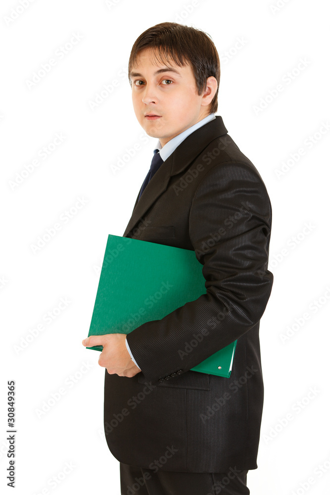 Serious modern businessman holding folder in hand Serious modern businessman holding folder in hand