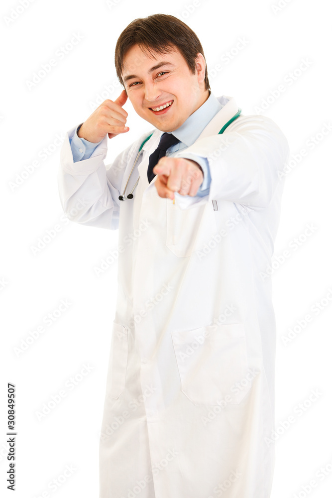 Cheerful medical doctor showing contact me gesture Cheerful medical doctor showing contact me gesture