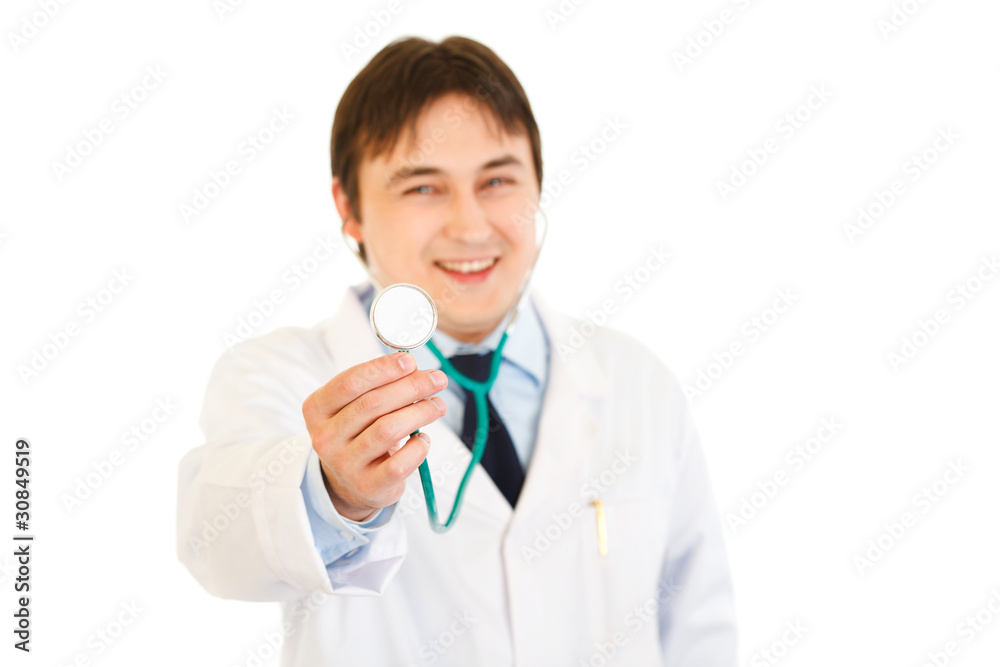 Pleased medical doctor holding up stethoscope. Close-up. Pleased medical doctor holding up stethoscope. Close-up.