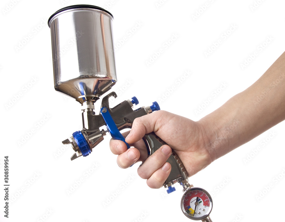 Hand and spray gun at work