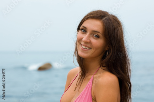 Smiling beautiful girl on the beach