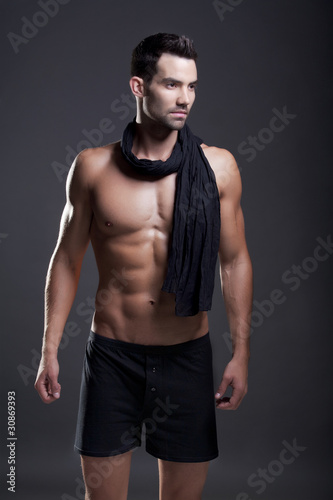 Closeup of a muscular handsome man in underwear © wtamas