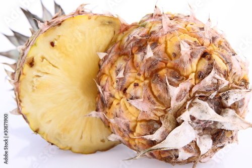 Pineapple - cut in half, in close up on white background