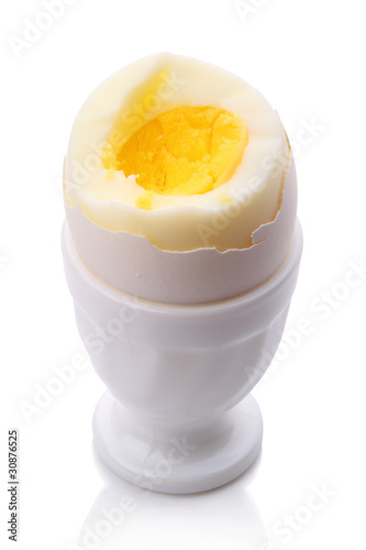 Single egg in cup on white
