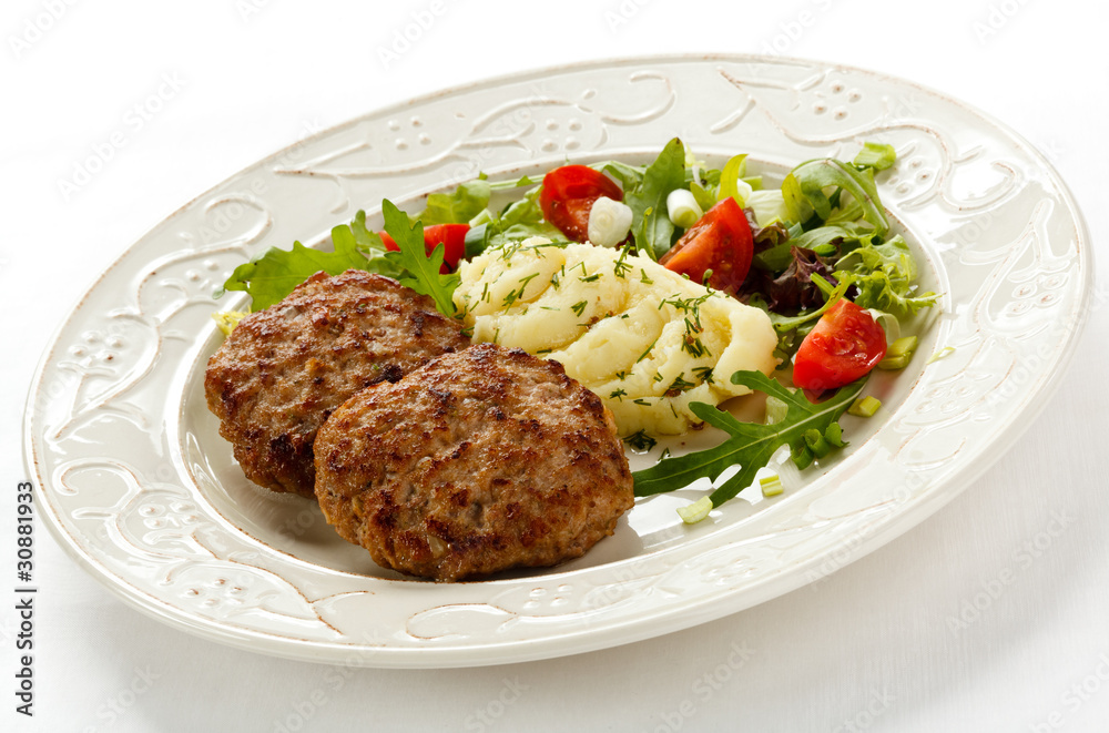Fried steaks with mashed potatoes and vegetable salad Fried steaks with mashed potatoes and vegetable salad