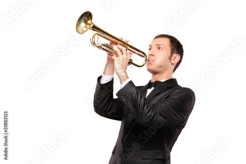 Young man in black suit playing a trumpet