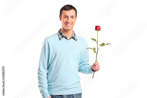 Young smiling man holding a rose flower