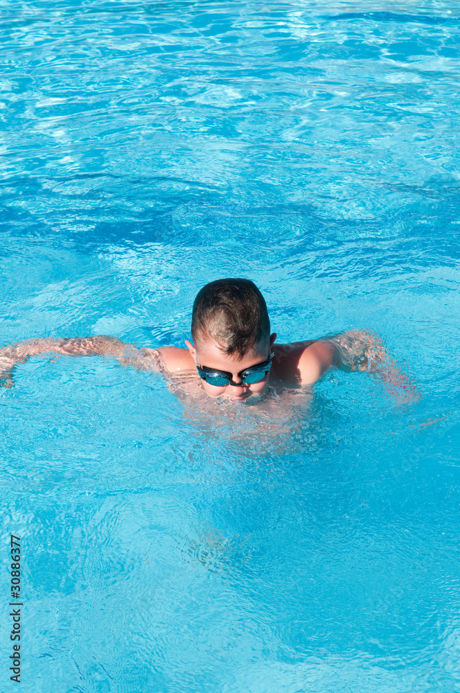 teenager swims in pool