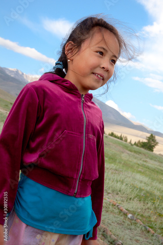 A girl stands in the Kazakh steppe