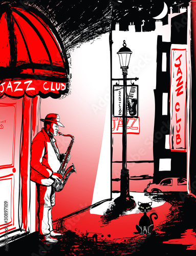 saxophone player in a street at night