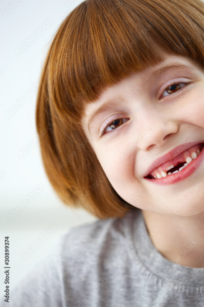 Closeup portrait of a cute smiling girl missing front teeth Closeup portrait of a cute smiling girl missing front teeth