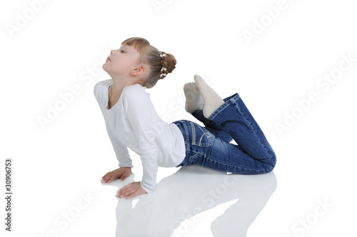 Charming little girl seated on the floor. Isolated on the white