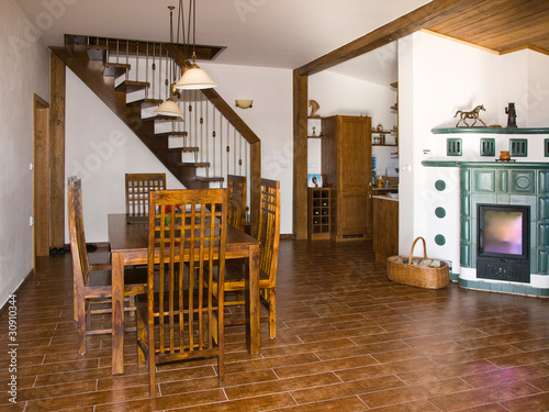 Interior of dinning room and tiled stove photo