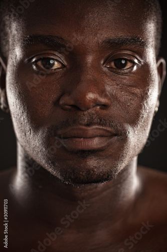 A young black man staring at you