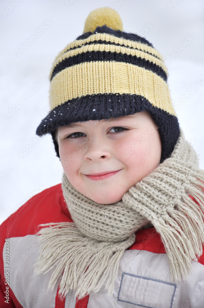 Portrait of a boy of seven in winter clothes