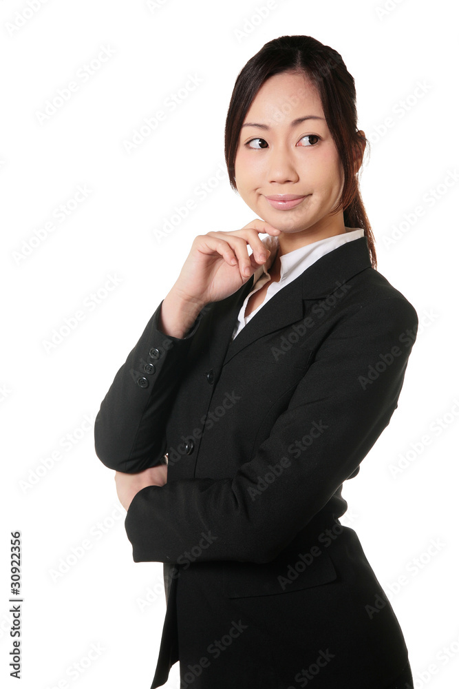 顎に手を当てて考えるスーツの女性 Stock Photo Adobe Stock