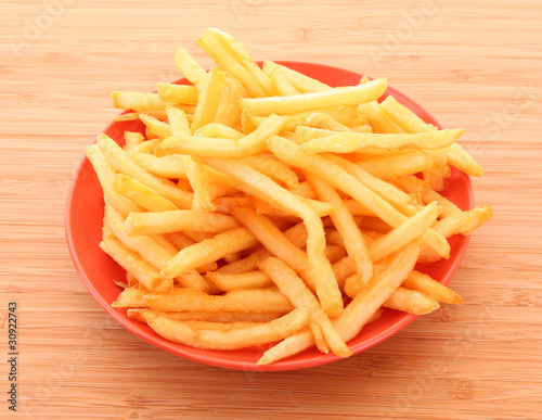 fried potatoes on the plate on white background