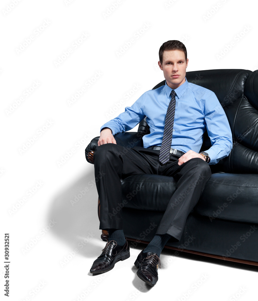 Young attractive bossy businessman sitting on the sofa. Young attractive bossy businessman sitting on the sofa.