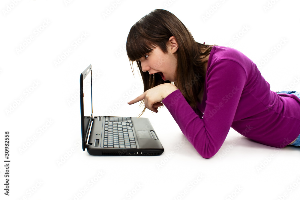 Surprised girl with laptop. Pointing at it Surprised girl with laptop. Pointing at it