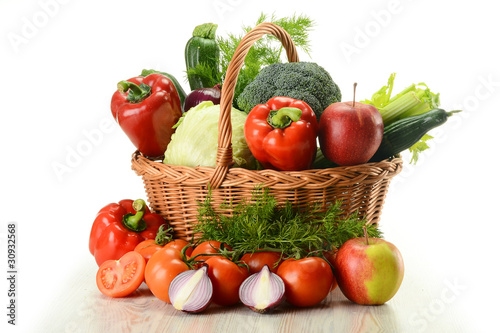 Vegetables in wicker basket isolated on white
