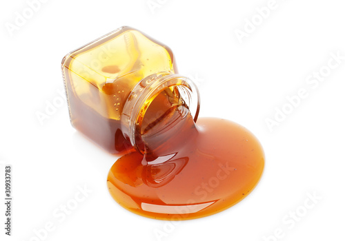 Honey spill from a glass jar