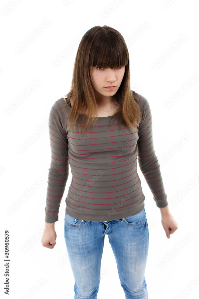 Angry teenage girl standing isolated against white background Angry teenage girl standing isolated against white background