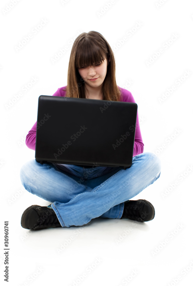 Naklejka premium Happy smiling girl working on laptop isolated on white