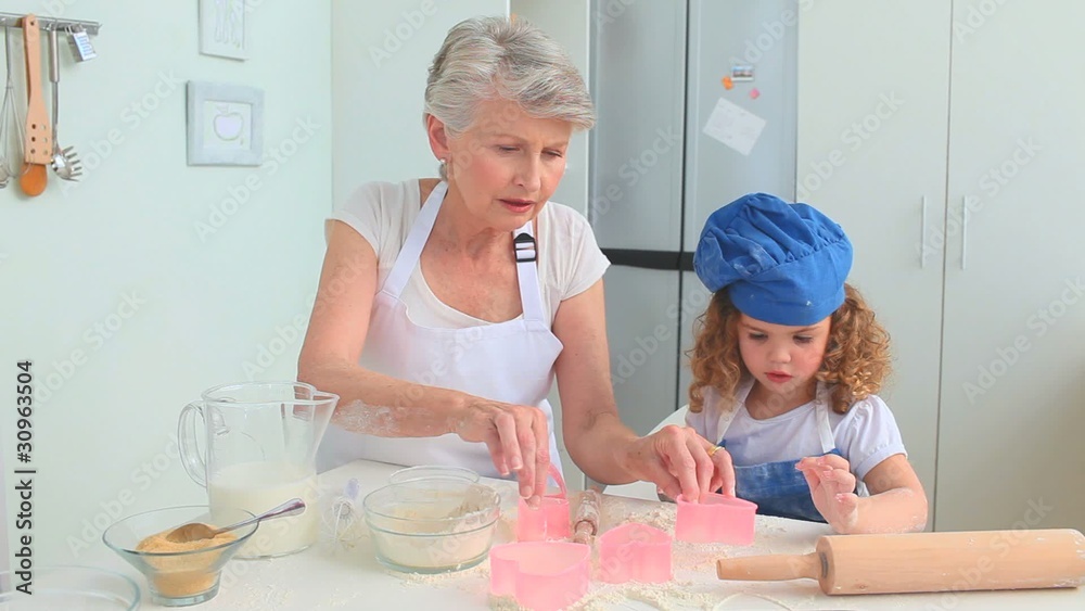 Grandmother and her grand daughter cooking together Grandmother and her grand daughter cooking together