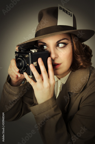 Retro looking model holding a vintage camera.