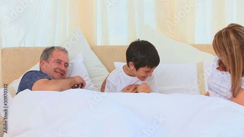 A little boy laughing with his grandparents photo