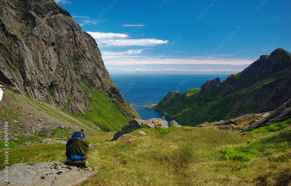 Young male hiker resting on the Lofoten, Norway