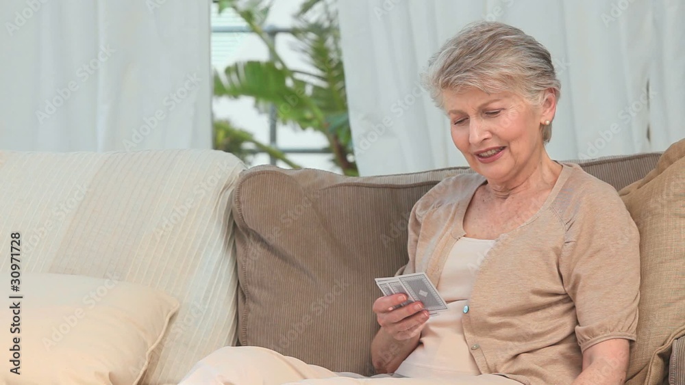 Aged woman playing cards Aged woman playing cards