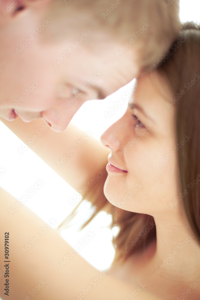 Embracing sweet couple looking at each other Embracing sweet couple looking at each other