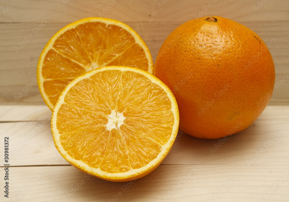 Cut and Whole Orange on Wood Board Cut and Whole Orange on Wood Board