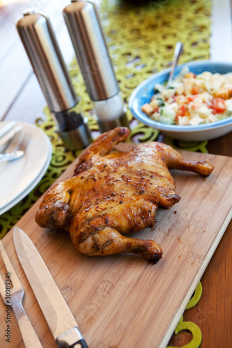 Whole cooked chicken served with salad